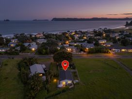 A view of houses near the ocean at Cozy Cottage - Whitianga Holiday Home, Whitianga