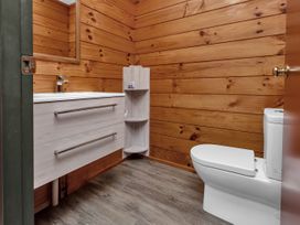 A bathroom with a sink and toilet at Matapouri Holiday Home in Whangarei