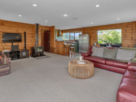 A living room with a sofa and television at Matapouri Holiday Home in Whangarei
