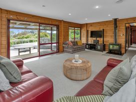 A living room with a coffee table and television at Matapouri Holiday Home Whangarei