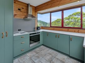 A kitchen with cabinets and an oven at Matapouri Holiday Home Whangarei