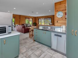 A kitchen with a sink and microwave at Matapouri Holiday Home Whangarei