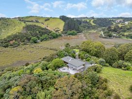 A house surrounded by trees and grass at Matapouri Holiday Home Whangarei