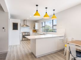 A kitchen with a stove and sink at Happy Place - Waihi Beach Holiday Home Waihi Beach