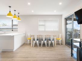 A dining room with a table and chairs at Happy Place - Waihi Beach Holiday Home Waihi Beach