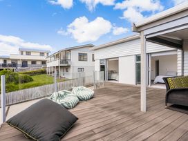 An outdoor area with a deck and bean bags at Happy Place - Waihi Beach Holiday Home Waihi Beach