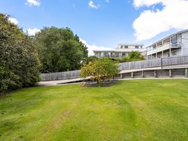 A garden with grass and trees at Happy Place - Waihi Beach Holiday Home, Waihi Beach