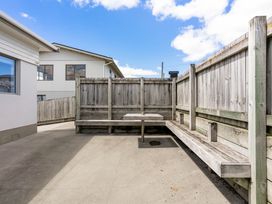 An outdoor area with a bench surrounded by a wooden fence at Happy Place - Waihi Beach Holiday Home Waihi Beach
