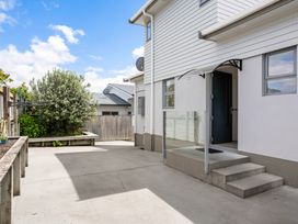 An outdoor area with steps and a glass railing at Happy Place - Waihi Beach Holiday Home, Waihi Beach