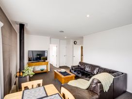 A living room with a sofa and coffee table at Cozy on Clive - Hastings Holiday Home