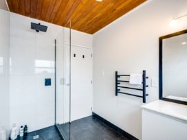 A bathroom featuring a shower and towel rack at Cozy on Clive - Hasting Holiday Home Hastings