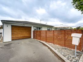 A house exterior with a garage and a fence at Cozy on Clive - Hastings Holiday Home