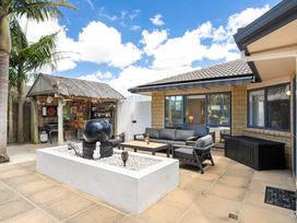 An outdoor seating area with a bar and table at Papamoa Beach in Papamoa
