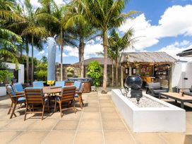 An outdoor area with seating and a bar at Papamoa Beach in Papamoa