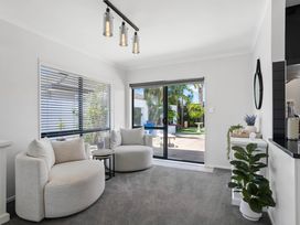 A living room with a sofa and coffee table at Papamoa Beach in Papamoa