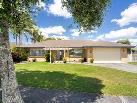 A house with a garage and front yard at Papamoa Beach, Papamoa