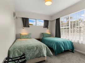A bedroom with two beds and a window at Amanda Lane - Snells Beach Holiday Home, Snells Beach