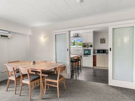A dining room with a table and chairs leading to the kitchen at Amanda Lane - Snells Beach Holiday Home Snells Beach