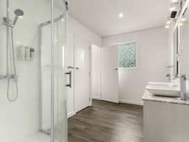 A bathroom with a shower and sinks at Amanda Lane - Snells Beach Holiday Home, Snells Beach