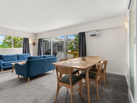 A living room with a sofa and dining area at Amanda Lane - Snells Beach Holiday Home Snells Beach