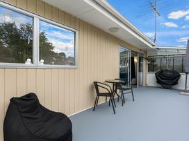 A balcony with a table and chairs at Amanda Lane - Snells Beach Holiday Home in Snells Beach