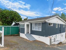 Exterior view of a house with stairs and a green shed at Amanda Lane - Snells Beach Holiday Home, Snells Beach