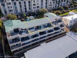 A building with balconies and outdoor furniture at Lakefront Penthouse - Central Queenstown Holiday Home Queenstown