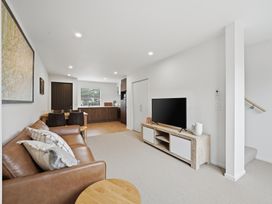 A living room with a television and sofa at Hanmer Alpine Chalet - Hanmer Springs