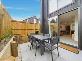 An outdoor patio with a table and chairs at Hanmer Alpine Chalet - Hanmer Holiday Home Hanmer Springs