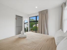 A bedroom with a bed and window at Hanmer Alpine Chalet - Hanmer Holiday Home