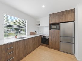 A kitchen with a sink, microwave, fridge, and oven at Hanmer Alpine Chalet - Hanmer Springs