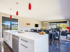 A kitchen and dining area with a sink and fruit bowl at Lake Hawea Holiday Home Wanaka