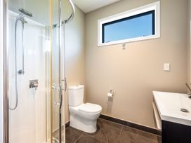 A bathroom with a shower, toilet, and sink at Lake Hawea Holiday Home in Wanaka