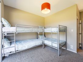 A bedroom with bunk beds and a lamp at Lake Hawea Holiday Home in Wanaka