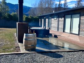 An outdoor area with a barrel and spa at Hawea Horizon - Lake Hawea Holiday Home