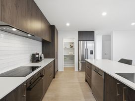 A kitchen with appliances and storage at Bliss at Madras - Christchurch Holiday Home