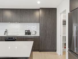 A kitchen with cabinets and appliances at Bliss at Madras - Christchurch Holiday Home