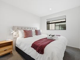 A bedroom with a bed and bedside table at Bliss at Madras - Christchurch Holiday Home