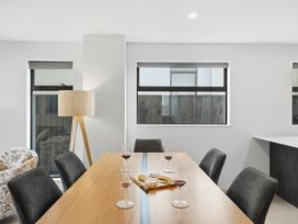 A dining room with a table and wine glasses at Bliss at Madras - Christchurch Holiday Home