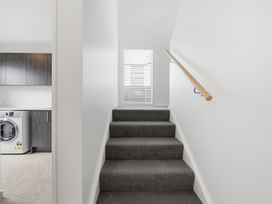 A staircase leading to a window at Bliss at Madras - Christchurch Holiday Home