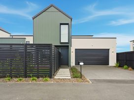 A modern house with a garage and pathway at Bliss at Madras - Christchurch Holiday Home