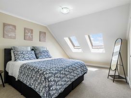 A bedroom with a bed and skylight windows at Sunlit Shores - Papamoa Holiday Homes, Papamoa