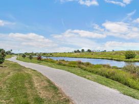 A walking path alongside a river at Sunlit Shores - Papamoa Holiday Homes, Papamoa