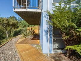 An outdoor area with a deck and plants at Lyttelton Holiday Home in Lyttelton