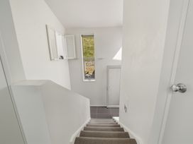 A staircase with a window and door at Lyttelton Holiday Home in Lyttelton