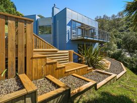 An outdoor view of a house with steps and a deck at Lyttelton Holiday Home in Lyttelton