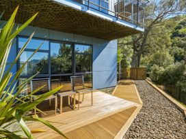 An outdoor area with chairs and decking at Lyttelton Holiday Home in Lyttelton