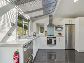 A kitchen with appliances and a sink at Lyttelton Holiday Home in Lyttelton