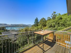 An outdoor area with a table and wine glasses at Lyttelton Holiday Home in Lyttelton