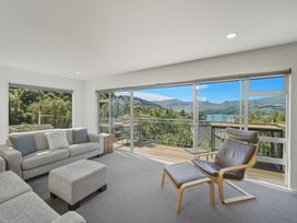 A living room with a sofa and armchair at Lyttelton Holiday Home in Lyttelton